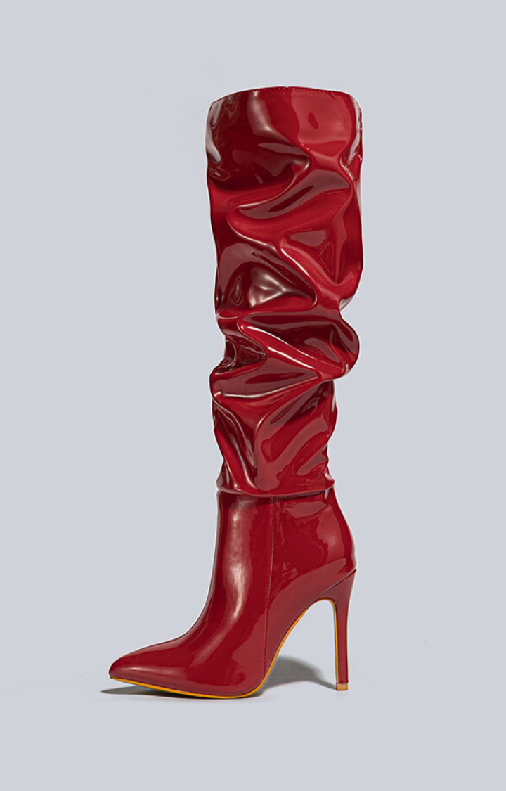 RIOT PATENT RUCHED KNEE-HIGH BOOTS IN CHERRY BLAZE